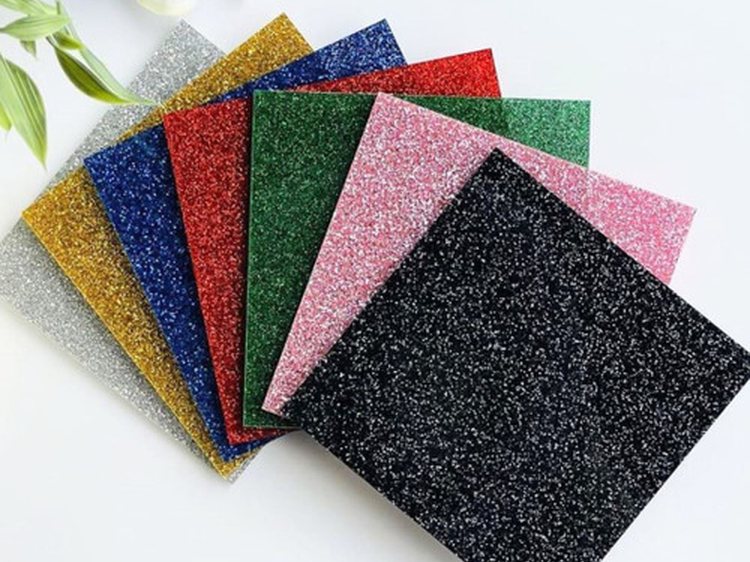 A fan of glitter acrylic sheets in gold, silver, black, red, green, pink and blue