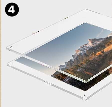 A landscape print laid between two clear acrylic panels