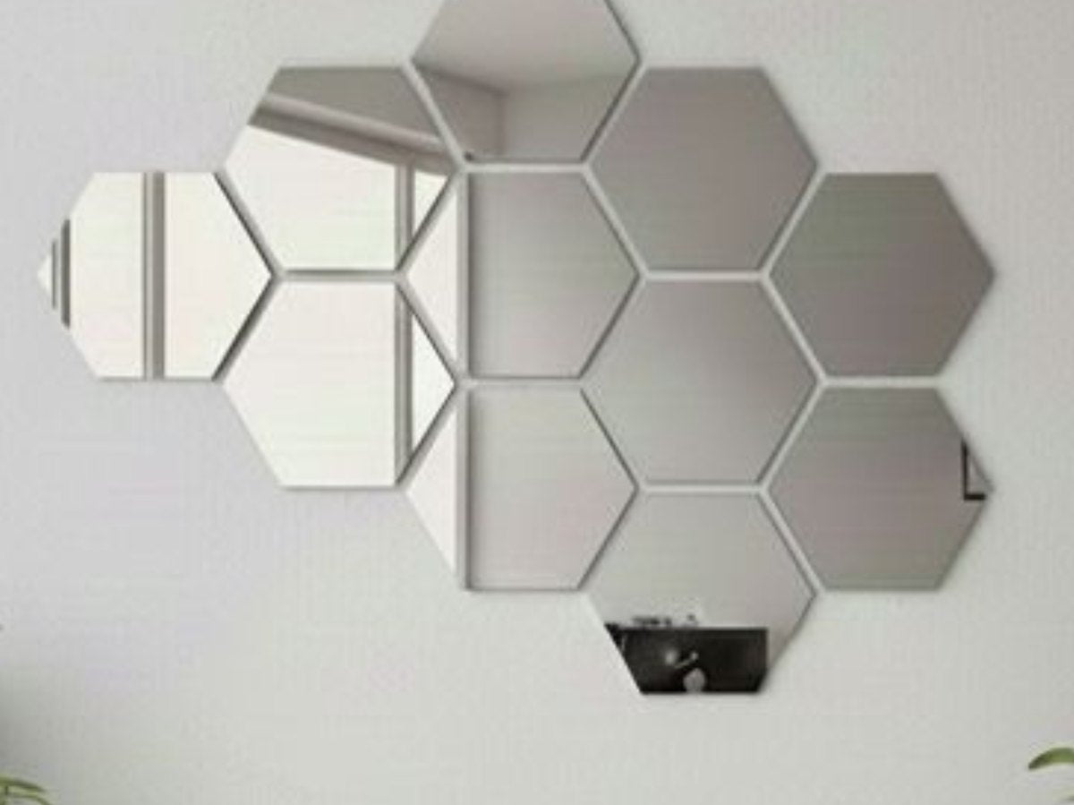 A cluster of silver mirror acrylic hexagons arranged on a wall