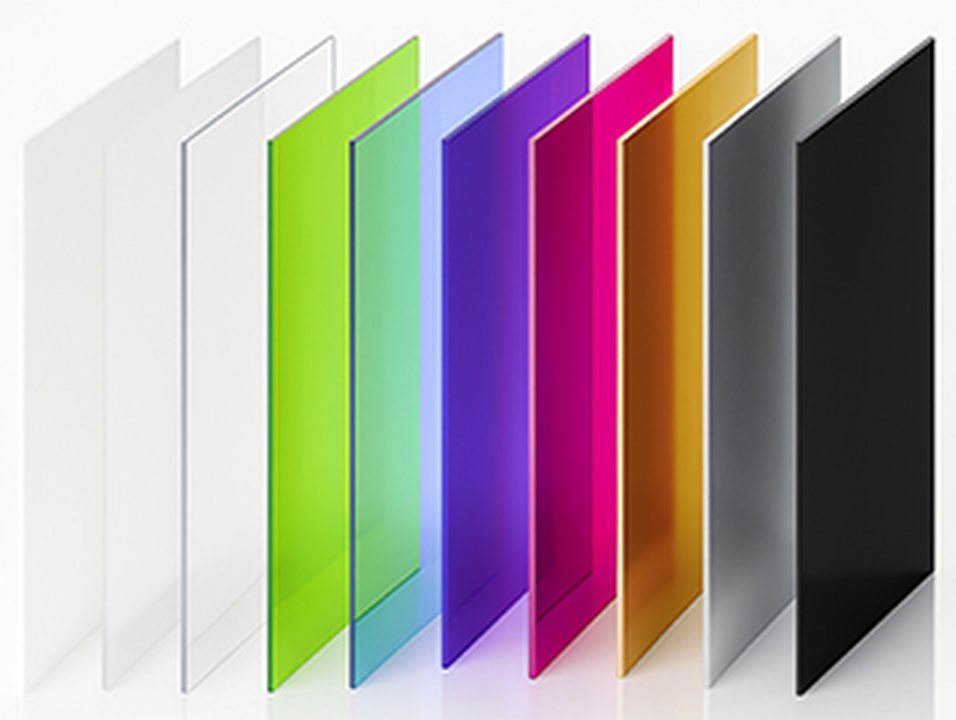 A row of acrylic sheets standing on edge: clear, frosted, white, green, blue, purple, pink, gold, grey and black