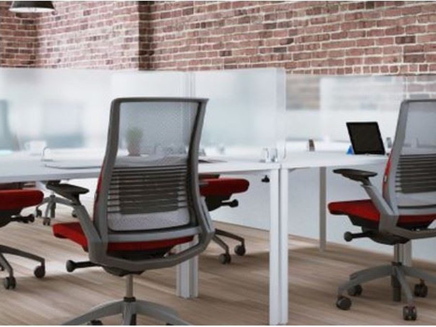 Frosted acrylic dividers between desks in an open office