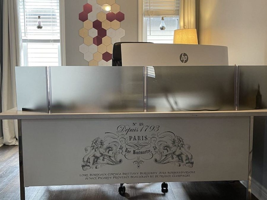 A grey frosted acrylic screen on a reception desk