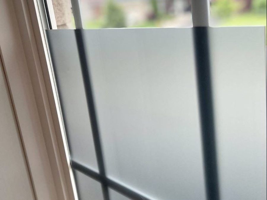 Grey frosted acrylic covering the lower half of a window